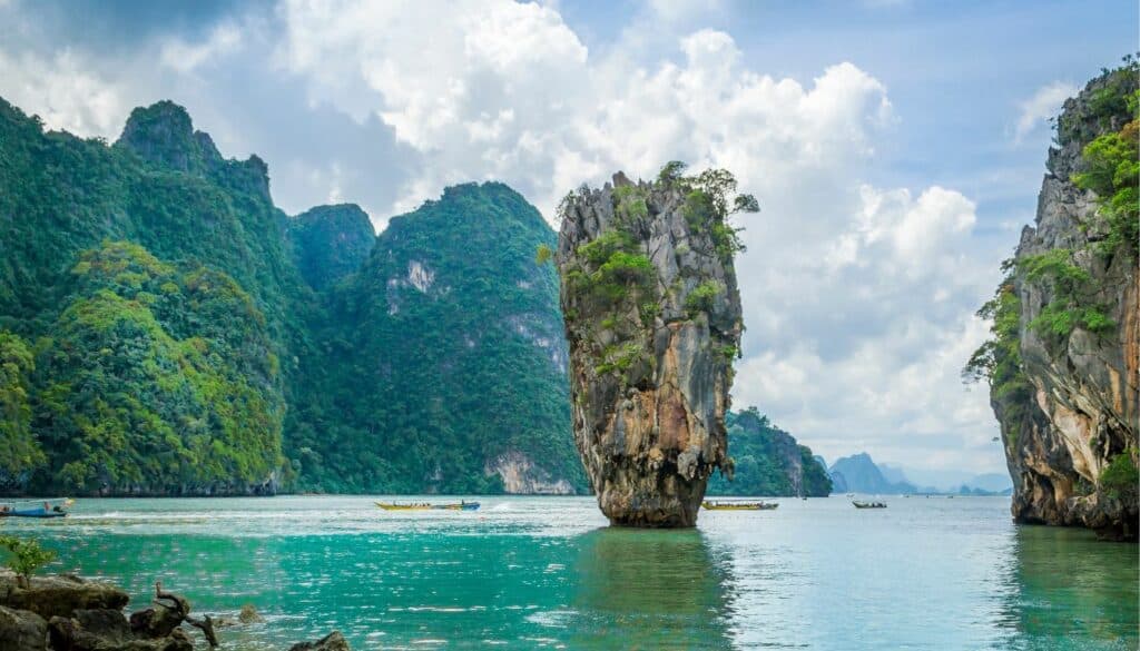 image of water with rocks in the middle. The picture is take in Thailand and shows one of the reasons to visit Thailand.